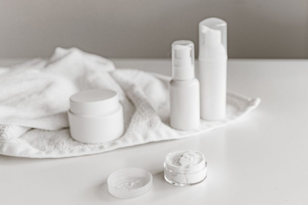 Elegant display of skincare products on a white surface, highlighting simplicity and purity.
